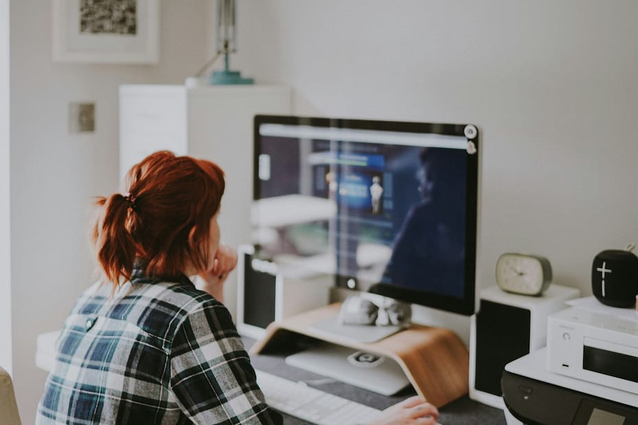 Woman browses the internet, researching IR35 regulations for contractors.