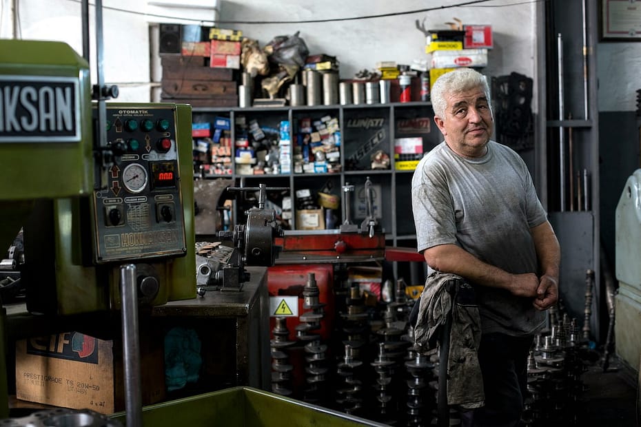 A worker on a factory floor; sole trader vs limited company structures shape how workplaces like this are organised.