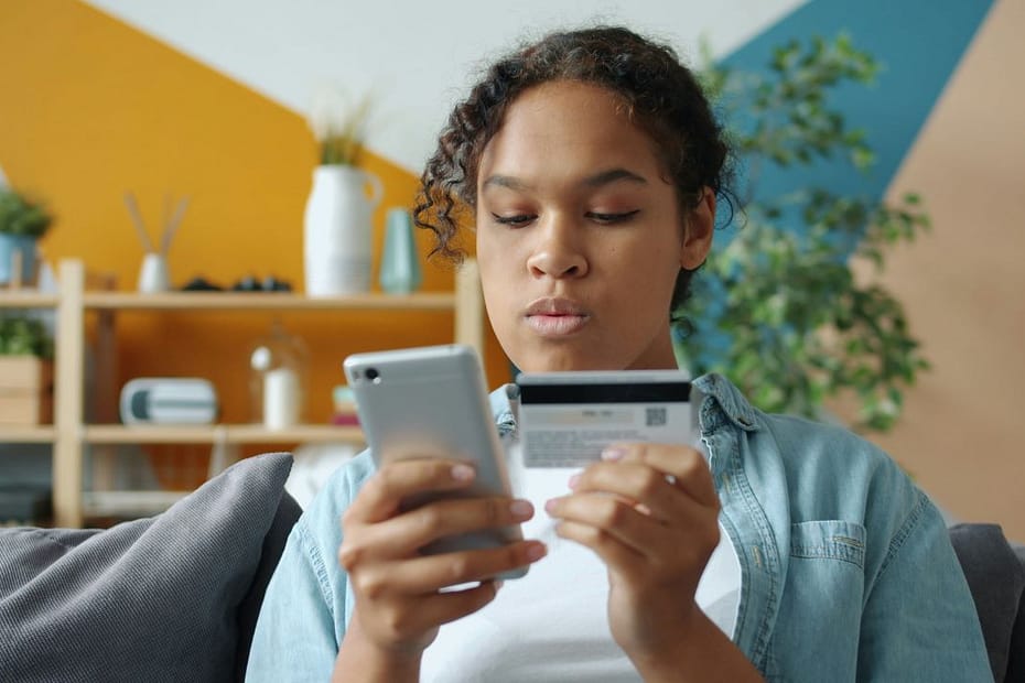 Woman making digital payments, reflecting employment income reported on SA102 form.