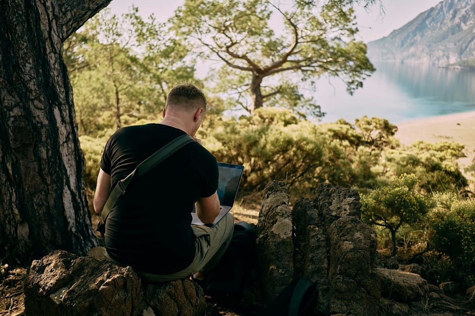 Remote worker in nature, completing SA106 form for overseas income.