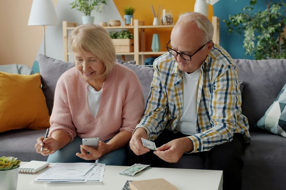 Seniors look over household finances, calculating pension tax relief for higher rate taxpayers