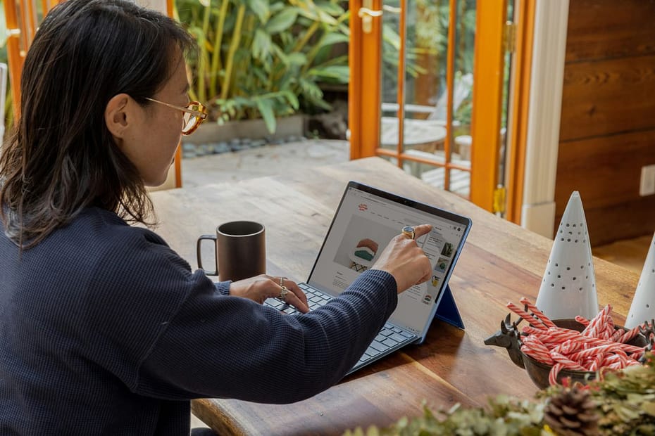 Woman working on a laptop at home, reviewing business asset disposal relief before selling a business.