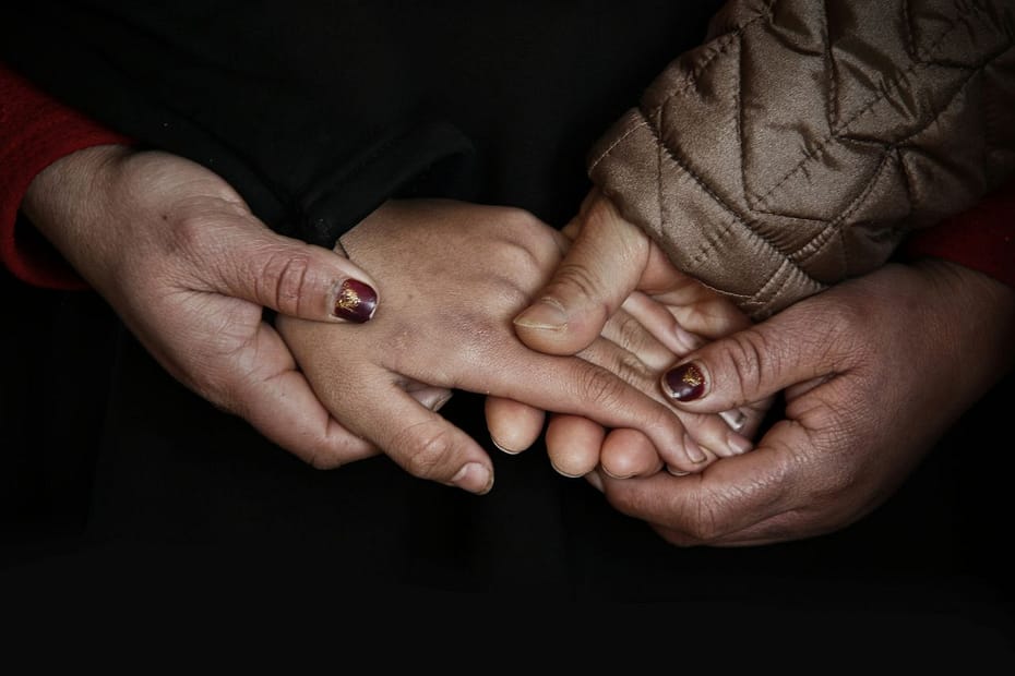 Hands held in a supportive circle, representing families navigating death duties in the UK.