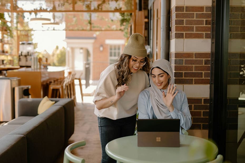 Woman at a kitchen table with a laptop, handling admin and keeping accounts as a sole trader.