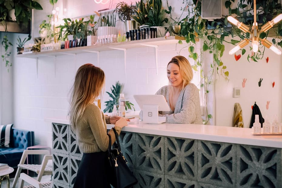 Woman working at a counter, reviewing how to pay yourself from a limited company.