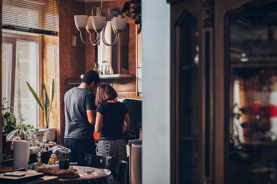Man and woman in a kitchen, discussing SA302 evidence for a mortgage application.