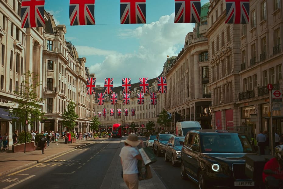 Regent Street with Union Jack flags, linked to UK tax questions like how do you claim emergency tax back.